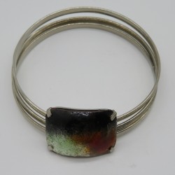 Three Chrome Plated Bangles with an Enamel Panel